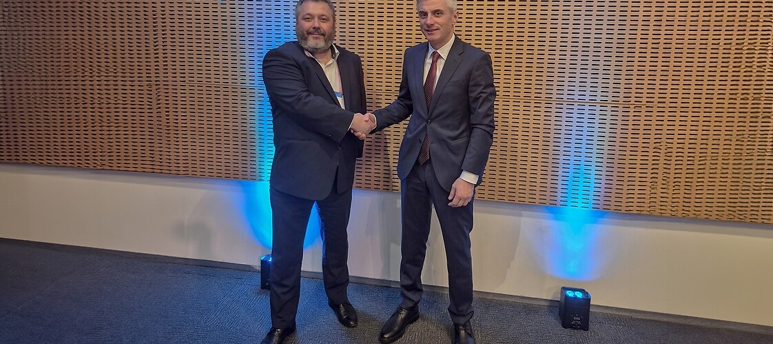 Two men in suits in conference space