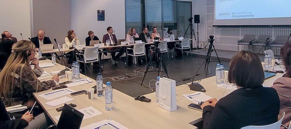 A group of people at tables in a conference room