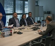 A group of people on both sides of the conference table